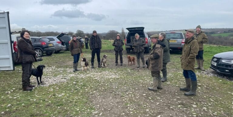 People and dogs preparing for a training session on the drop in day